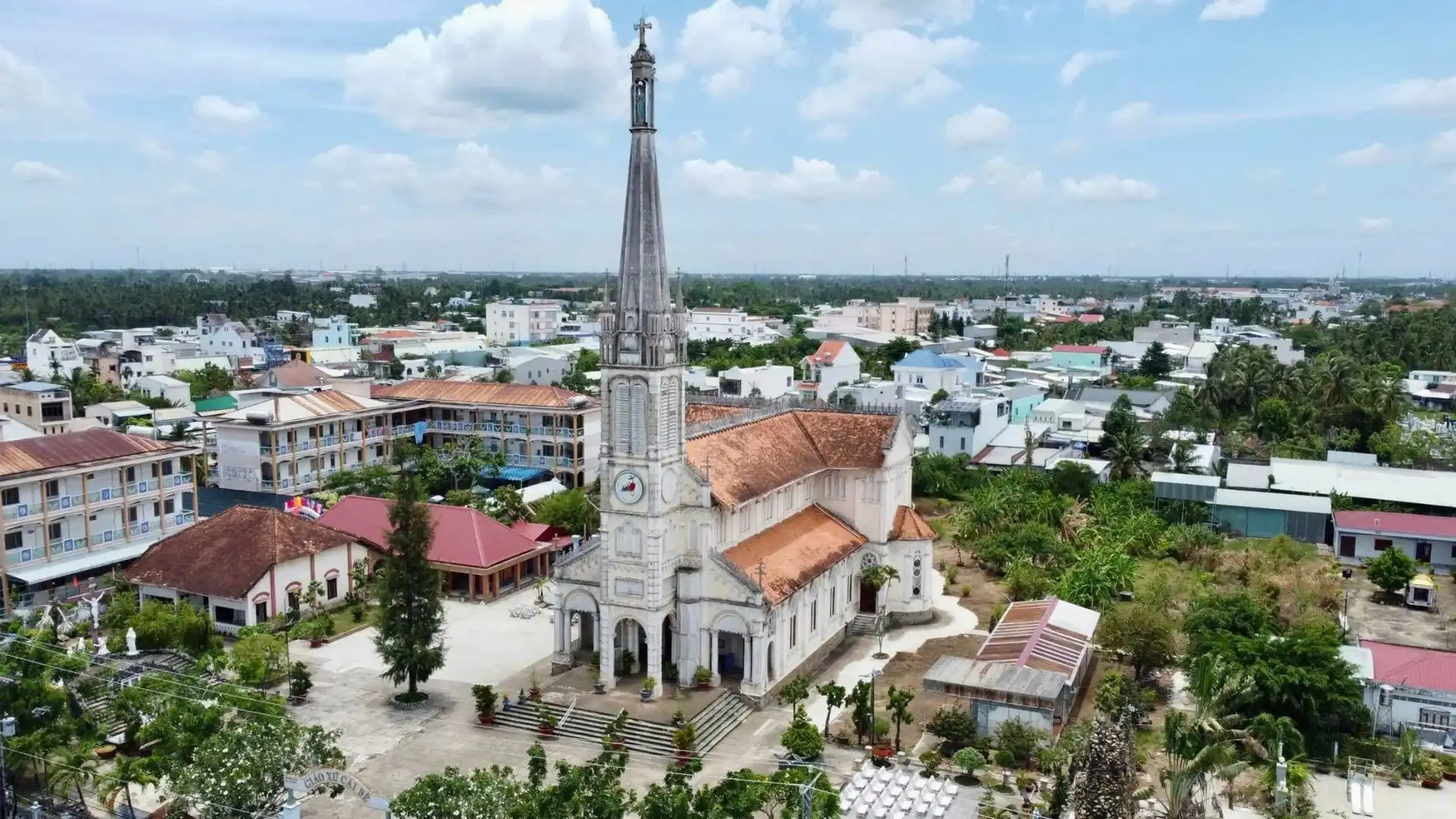 Cai Be Church aerial view in Cai Be, Tien Giang, Vietnam with surrounding houses and greenery