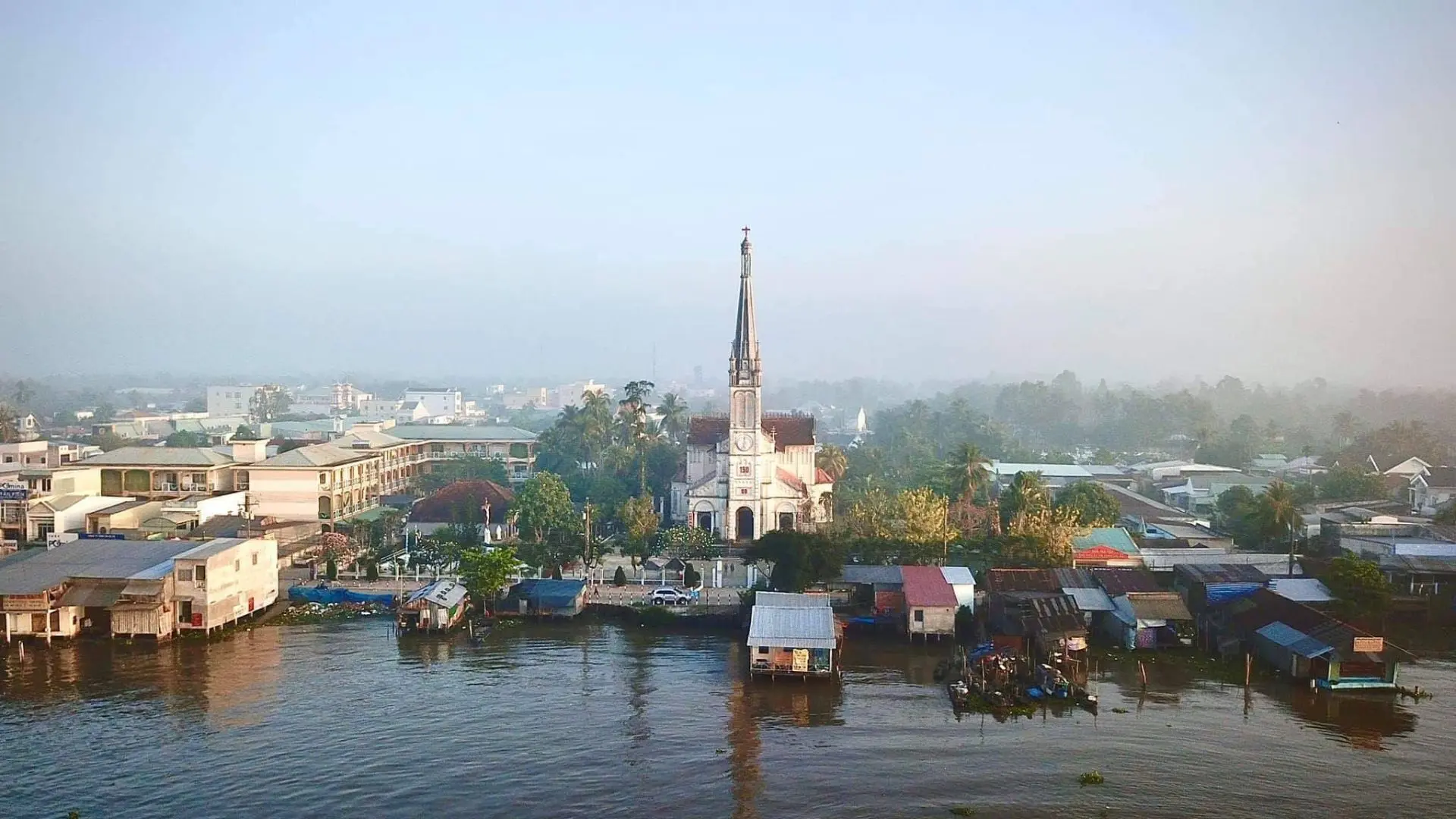 Cai Be Church near floating houses and Mekong Delta river life in Cai Be, Tien Giang, Vietnam