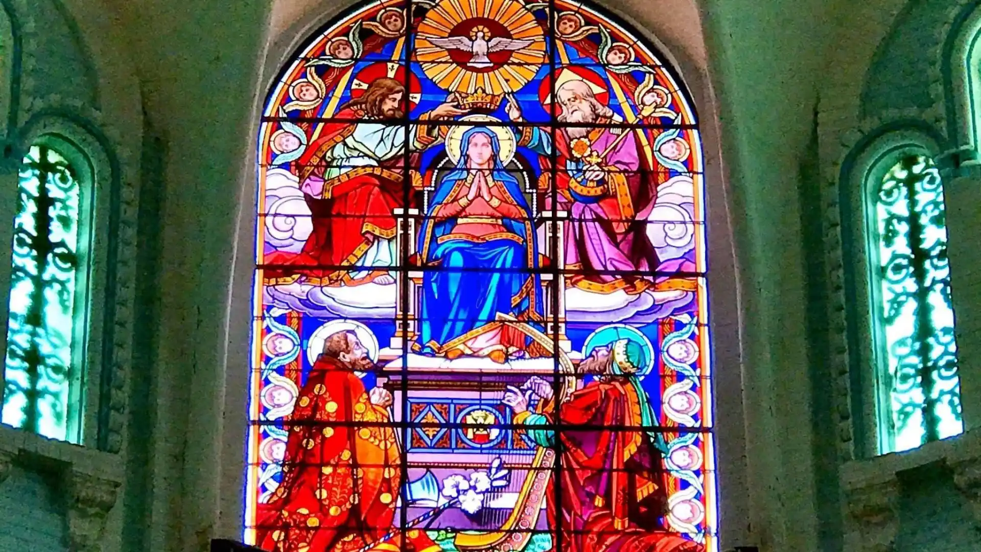 Stained glass window inside Cai Be Church in Cai Be, Tien Giang, Vietnam with religious imagery