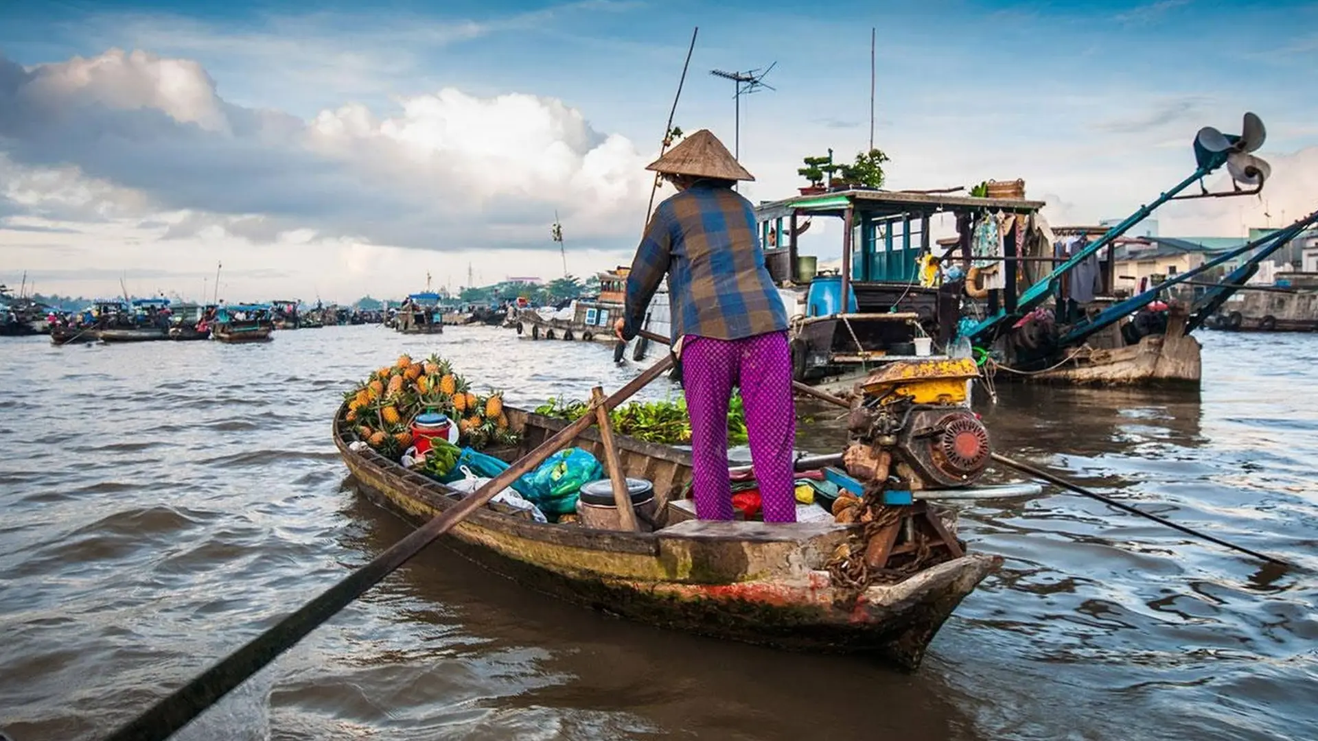 Mekong Smile Cai Be Floating Market local river life with vendors selling fruits from boats in daily trading activities