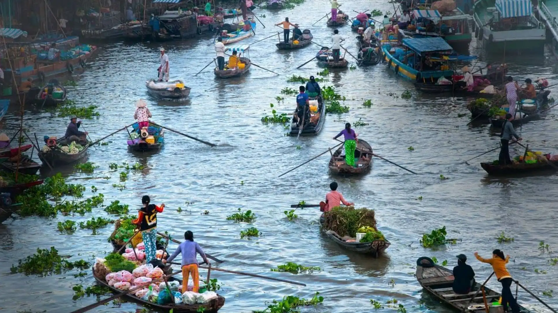 Mekong Smile Cai Be Floating Market local vendors selling goods from wooden boats