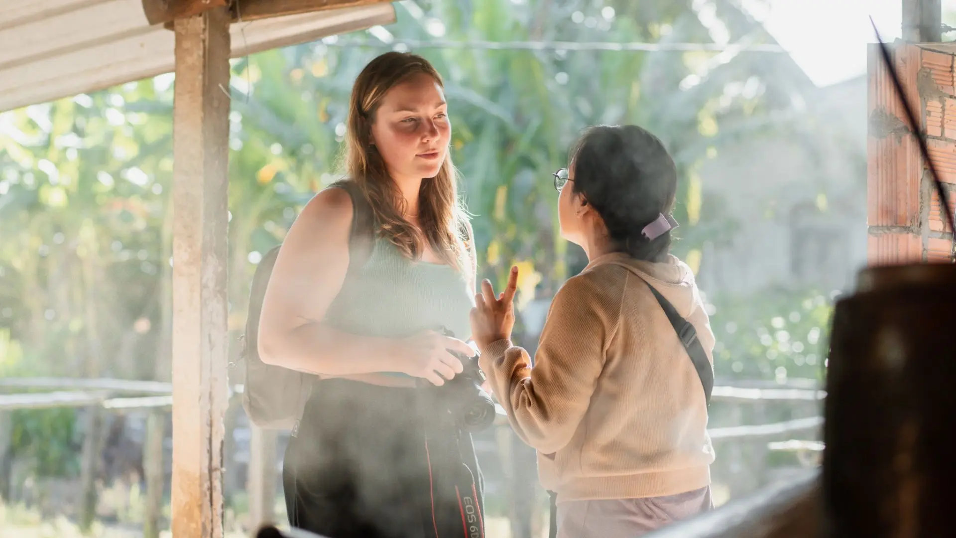 Tourists interacting with local people at Cai Rang Floating Market, Mekong Delta