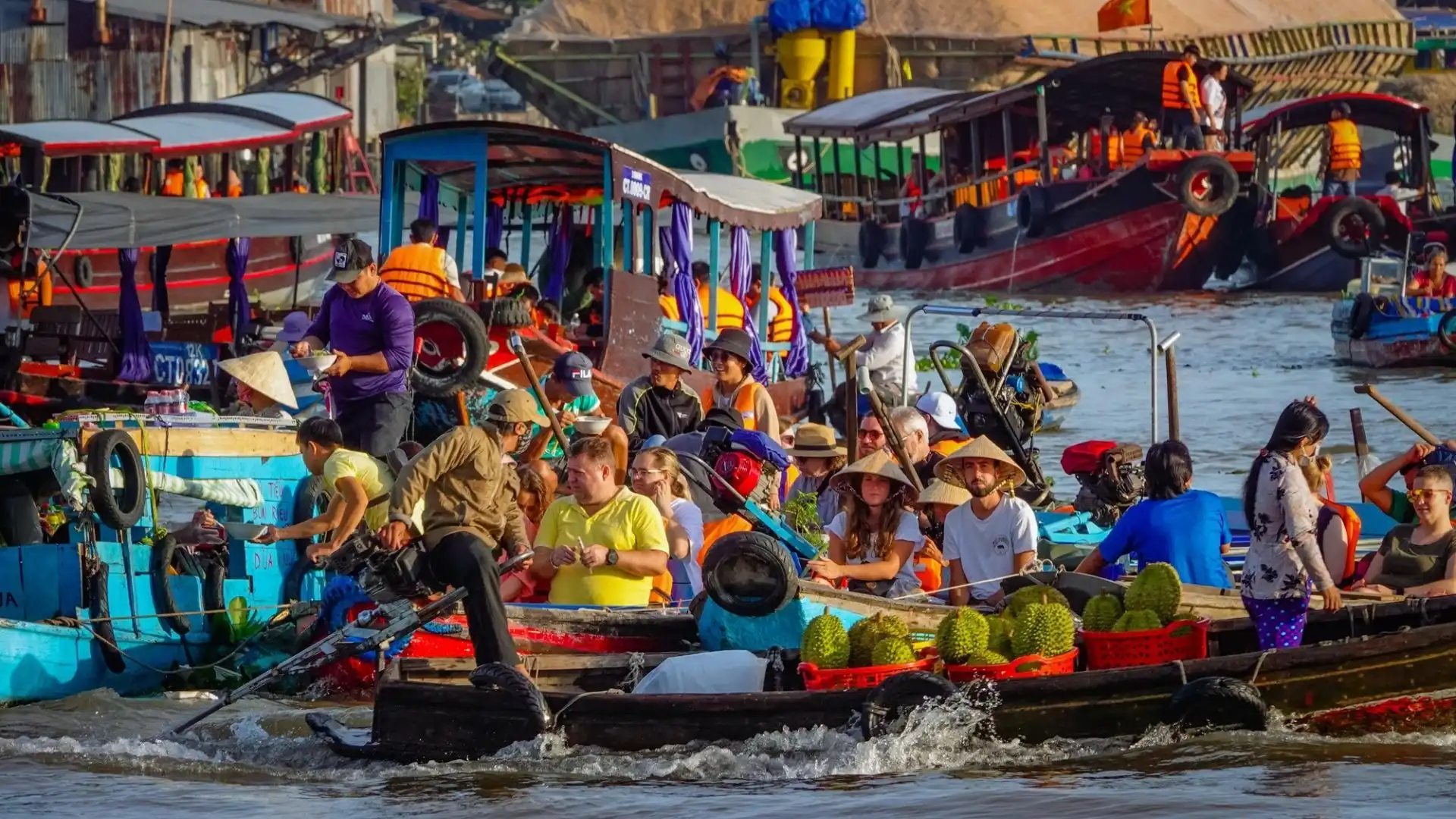 Busy trading boats loaded with fruits at Cai Rang Floating Market in the Mekong Delta