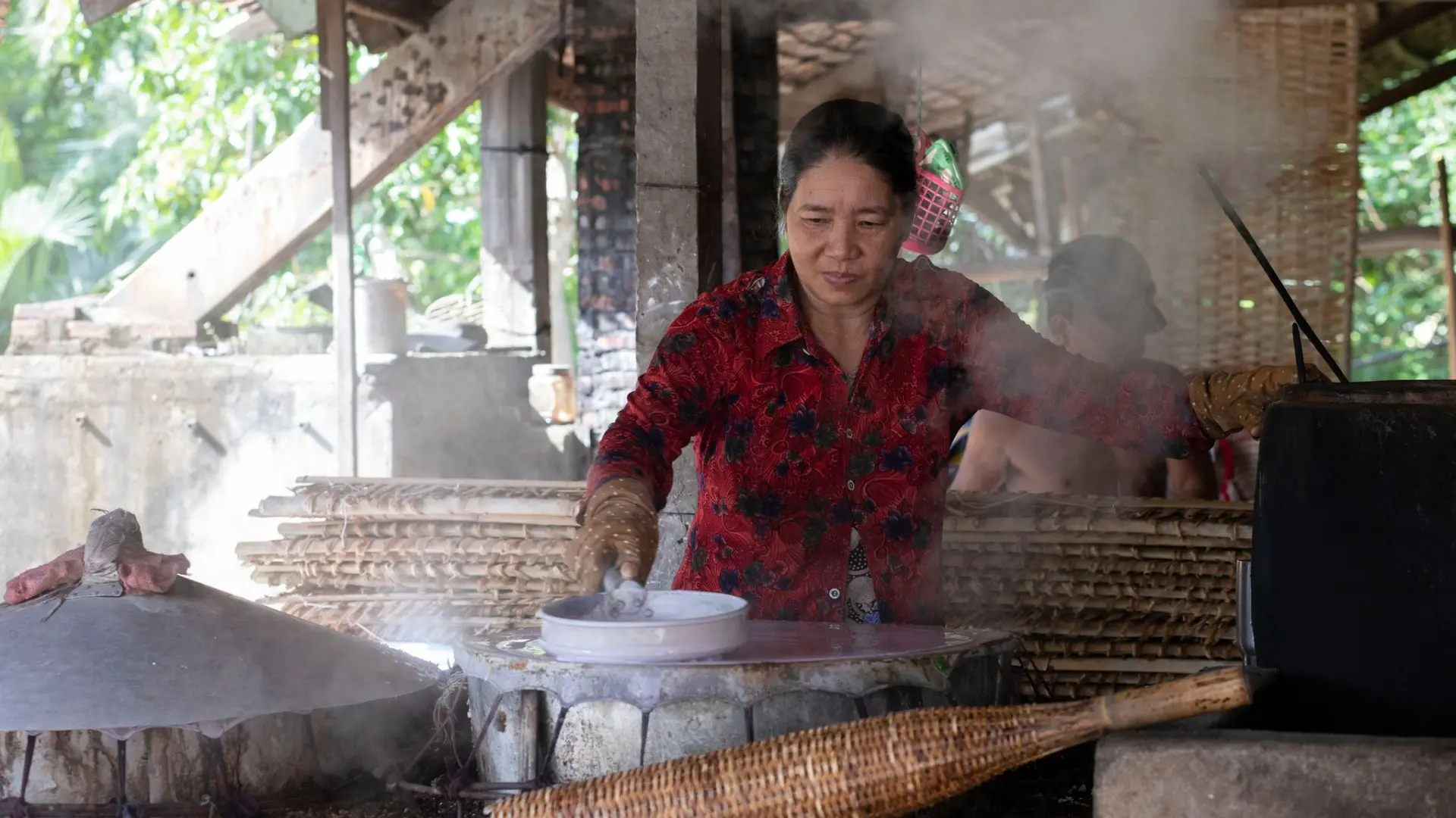 Local woman at traditional noodle wotkshop at Cai Rang Floating Market in Can Tho