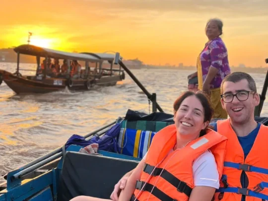 Tourists enjoying a sunrise boat ride at Cai Rang Floating Market, Mekong Delta