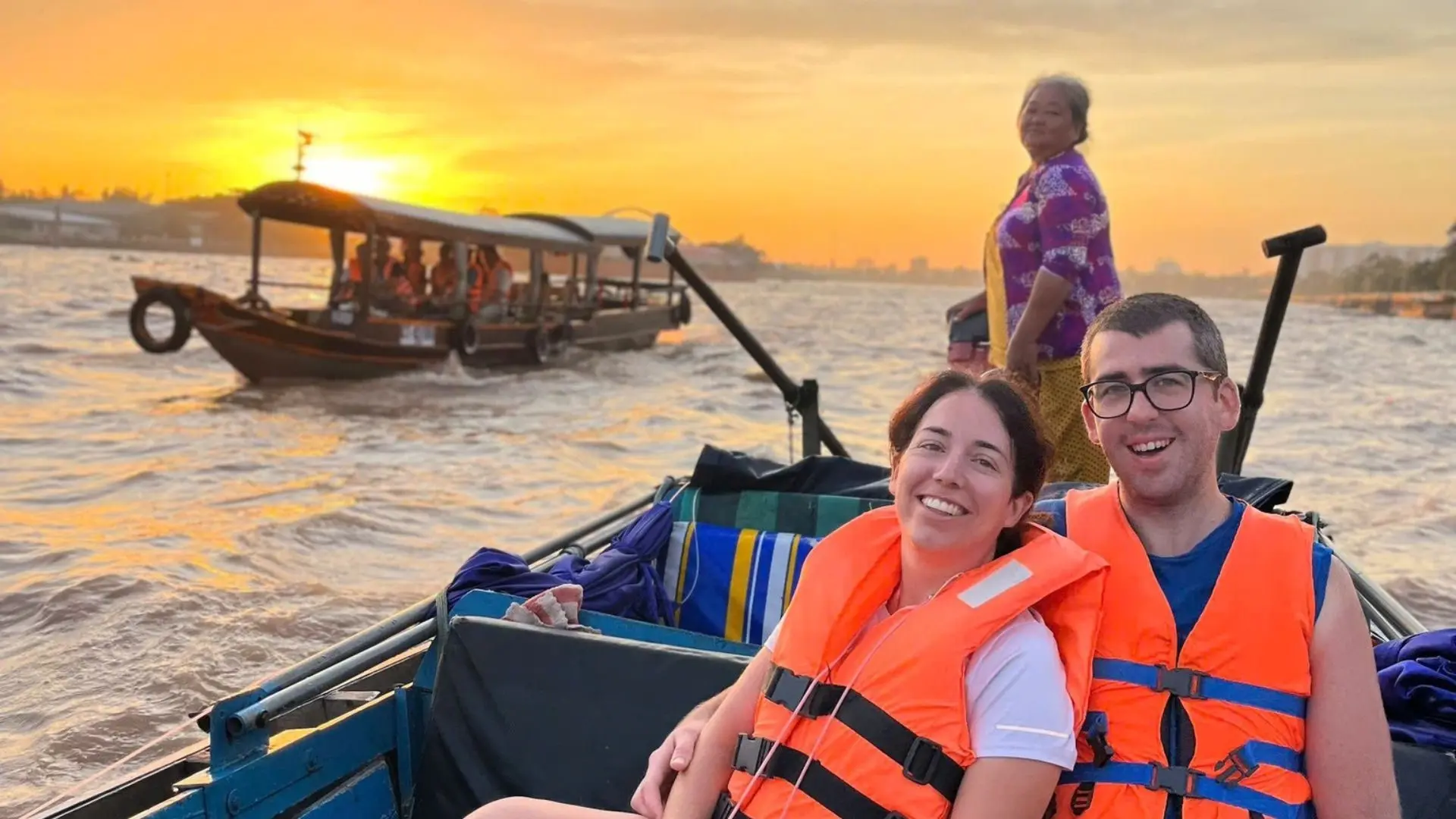 Tourists enjoying a sunrise boat ride at Cai Rang Floating Market, Mekong Delta