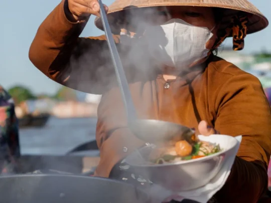 Traditional Vietnamese noodle soup prepared on a boat at Cai Rang Floating Market
