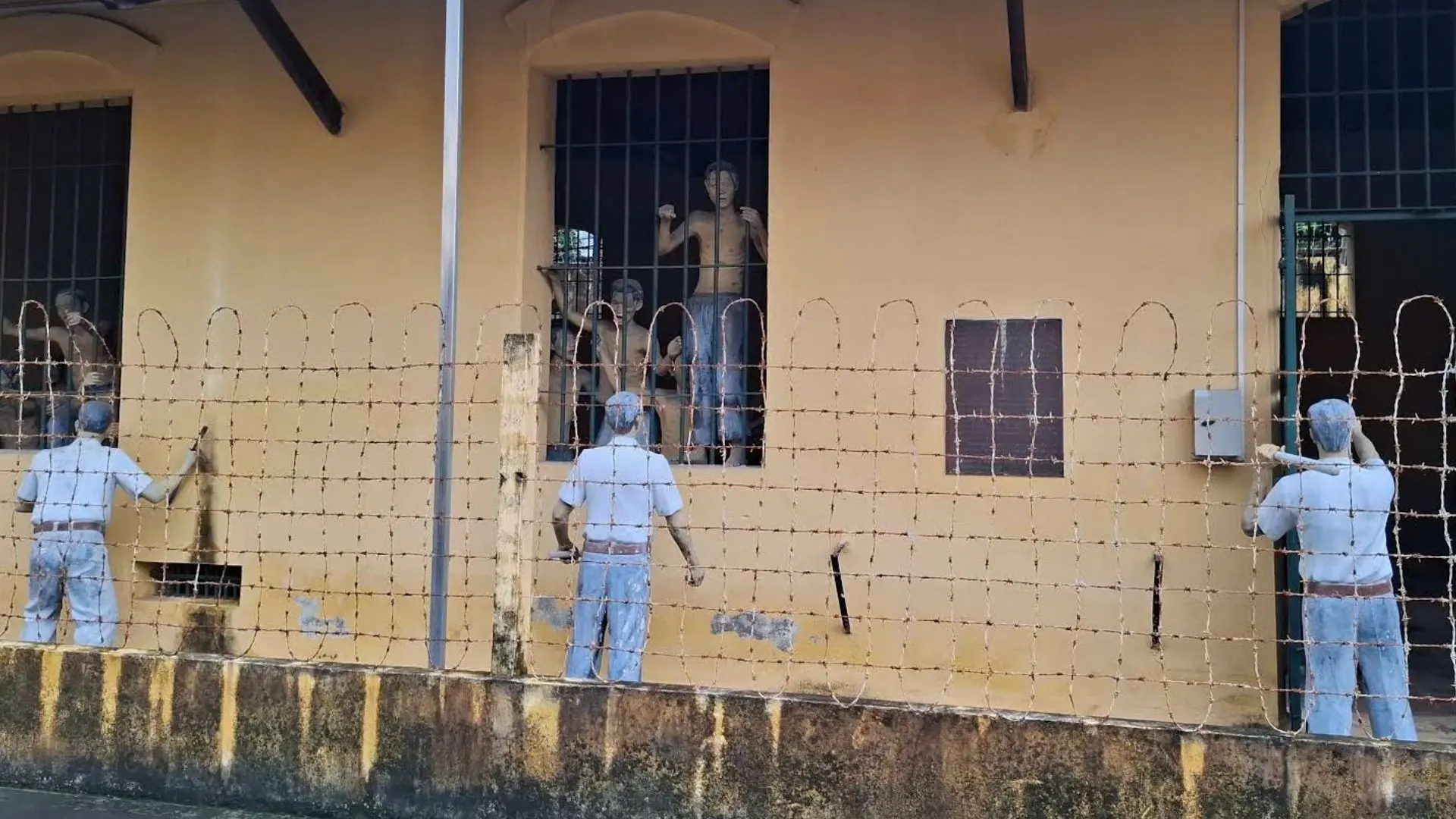 Old prison walls displaying historical marks at Can Tho Prison