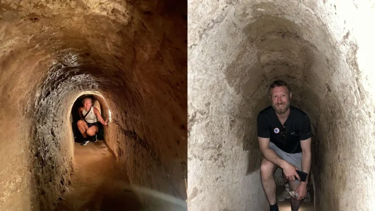 Tourists walking bent over due to the low ceiling in Cu Chi Tunnels Tour
