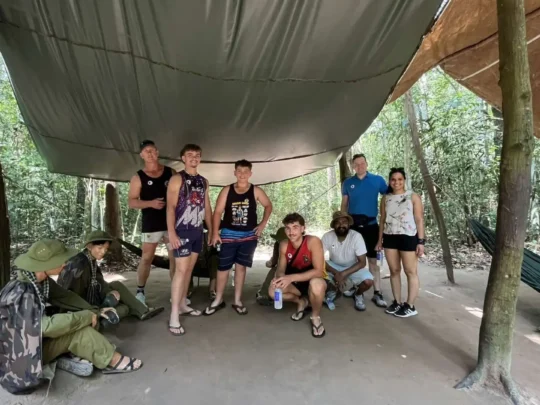 Tourists viewing a display or life-size model of wartime life in Cu Chi Tunnels Tour