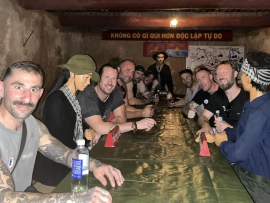 Interior view of a restored underground bunker/room with a simple wooden table.