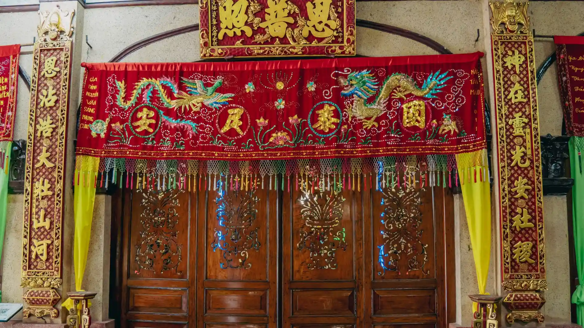 Red dragon embroidery banner at Dieu Hoa Temple entrance
