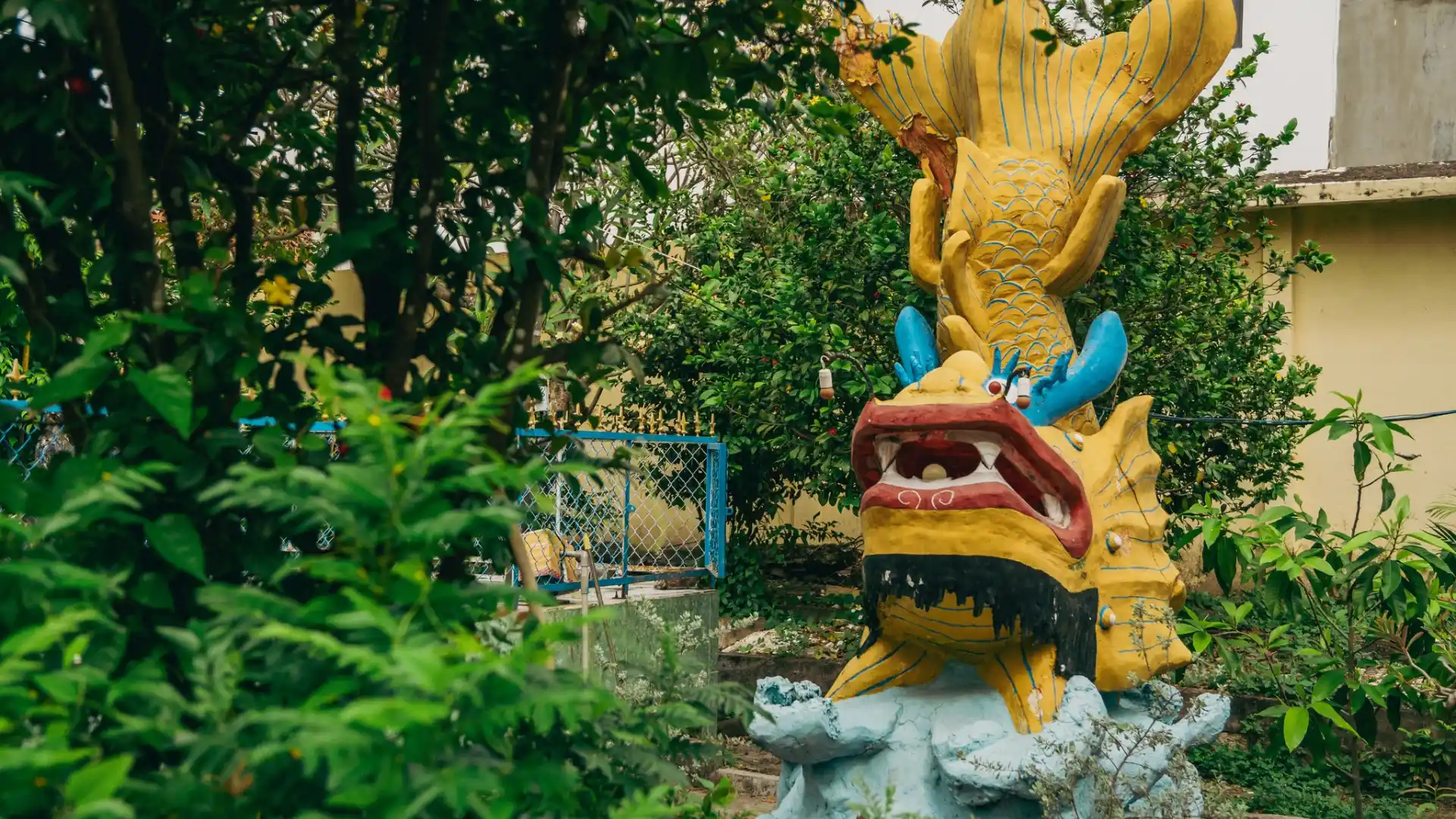 Colorful dragon statue among the greenery at Dieu Hoa Temple