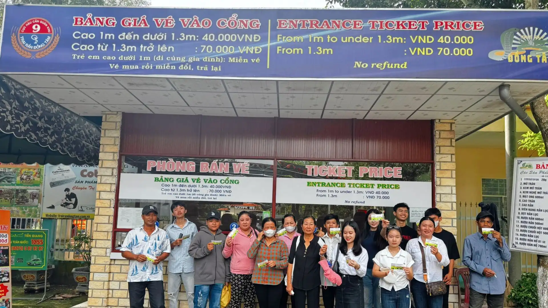 Tour group posing in front of the entrance building at Dong Tam Snake Farm in Tien Giang, a well-known attraction in the Mekong Delta