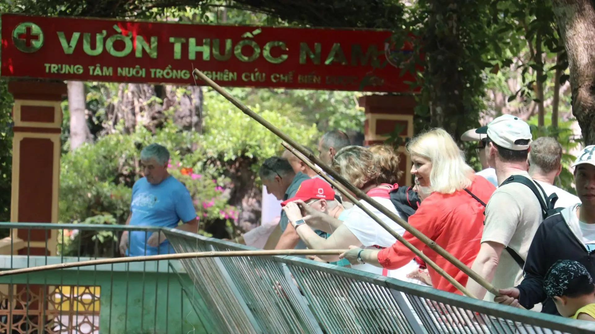Visitors exploring the medicinal herb garden at Dong Tam Snake Farm in Tien Giang, Vietnam