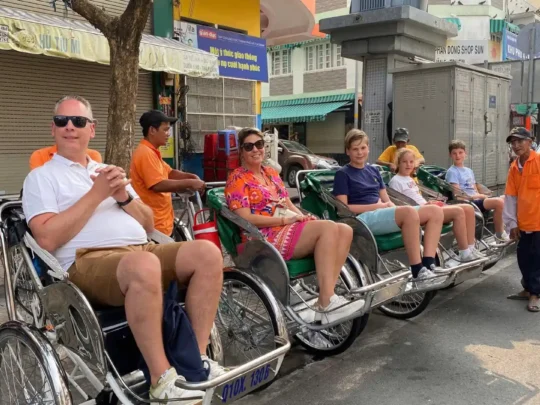 Group cycling through local neighborhoods on Ho Chi Minh Cycle Tour, Ho Chi Minh City