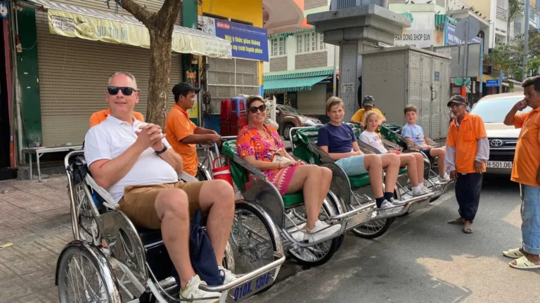 Group cycling through local neighborhoods on Ho Chi Minh Cycle Tour, Ho Chi Minh City