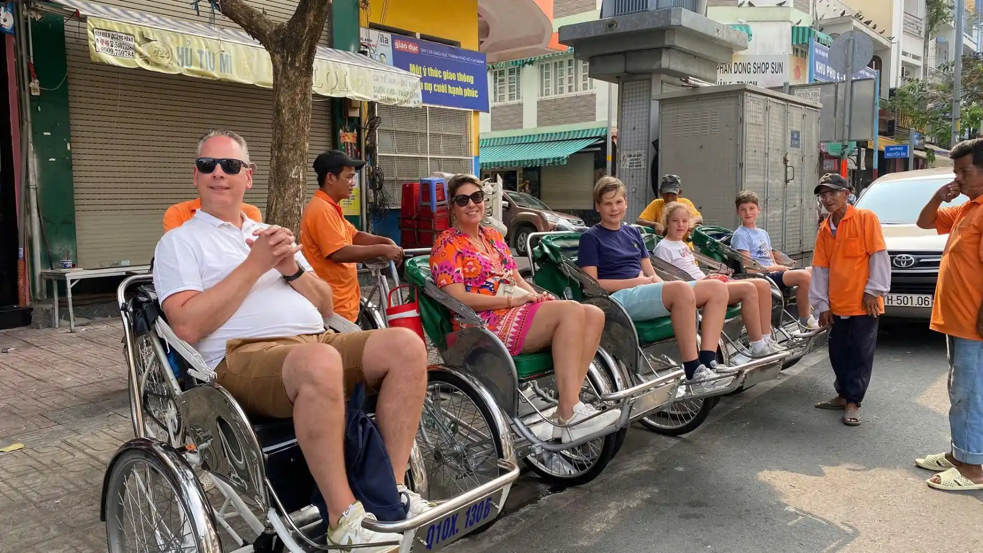 Group cycling through local neighborhoods on Ho Chi Minh Cycle Tour, Ho Chi Minh City