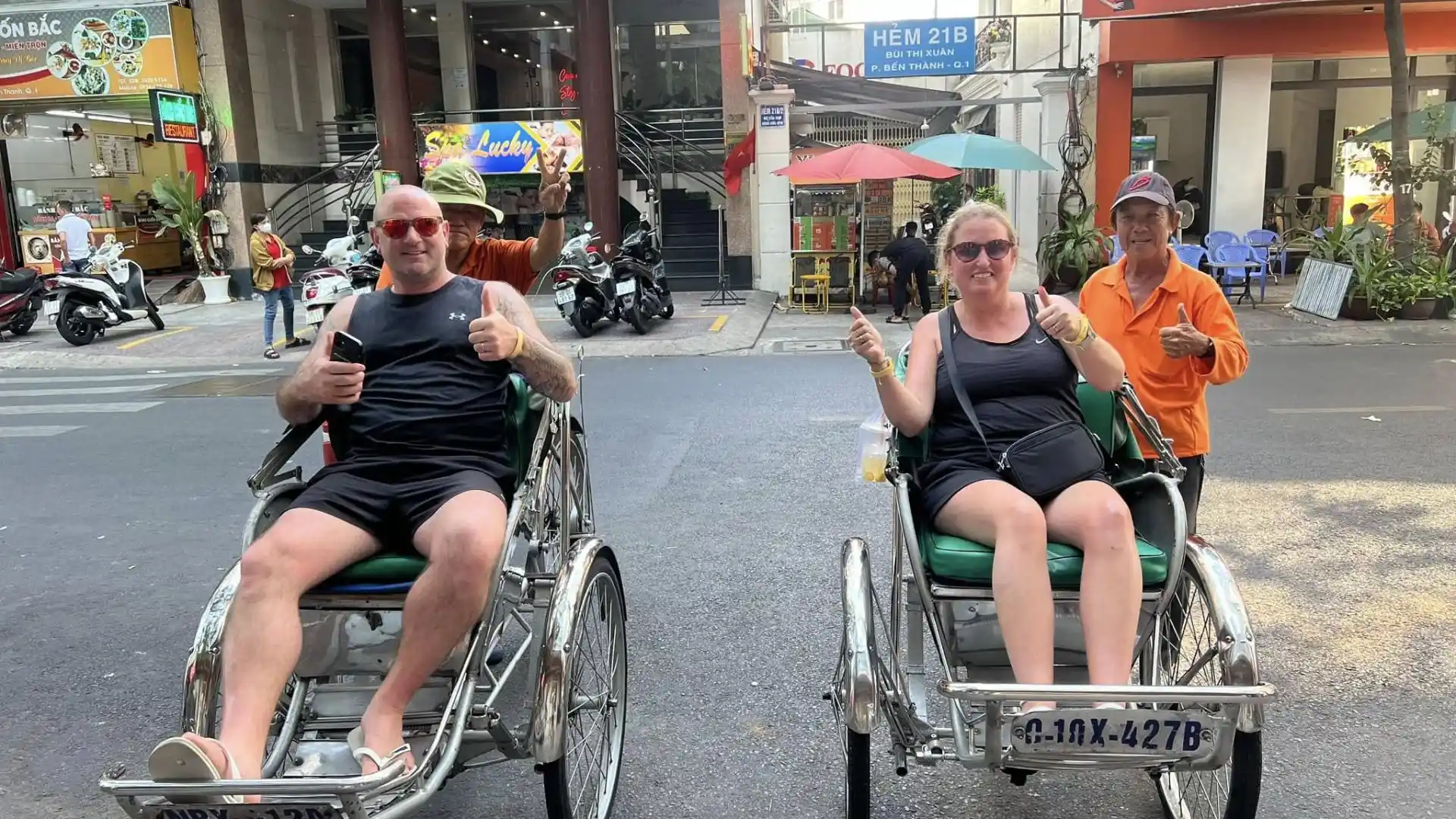 Tourists riding cyclos during a Ho Chi Minh Cycle Tour in Ho Chi Minh City