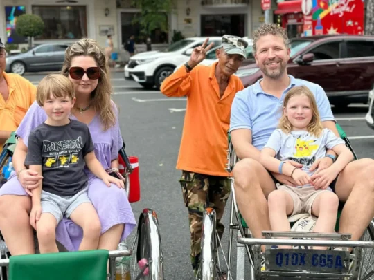 Family enjoying a cyclo ride on Ho Chi Minh Cycle Tour in Ho Chi Minh City