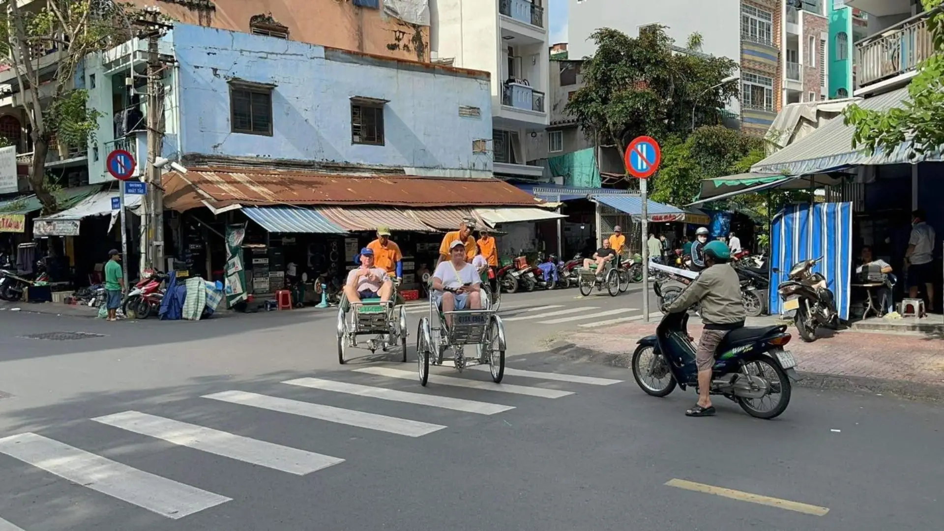 Cyclo crossing a local street on Ho Chi Minh Cyclo Tour in Ho Chi Minh City