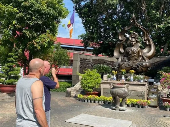 Tourists at the Burning Monk Memorial on Ho Chi Minh motorbike tour