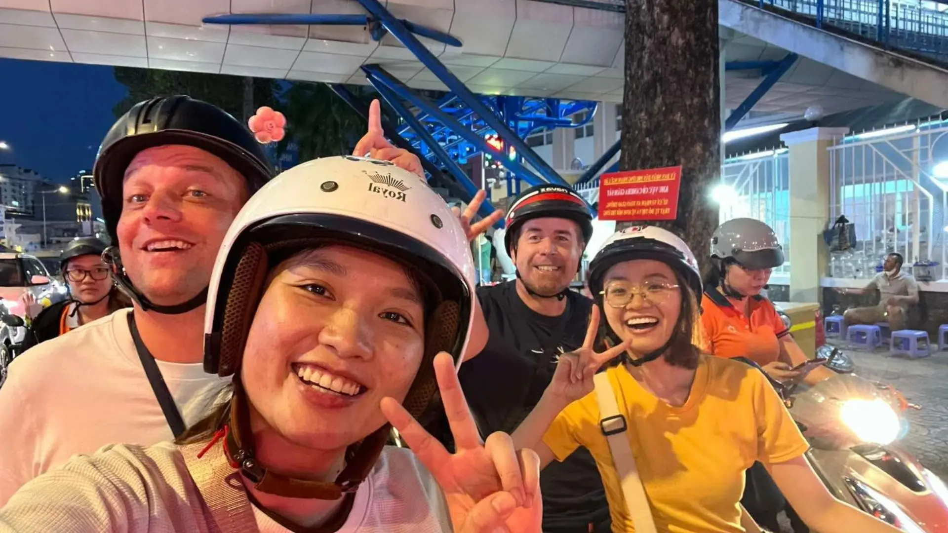 Tourists riding motorbikes at night during Ho Chi Minh City motorbike tour