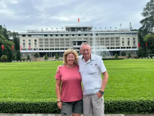 Tourists visiting Reunification Palace during Ho Chi Minh City motorbike tour