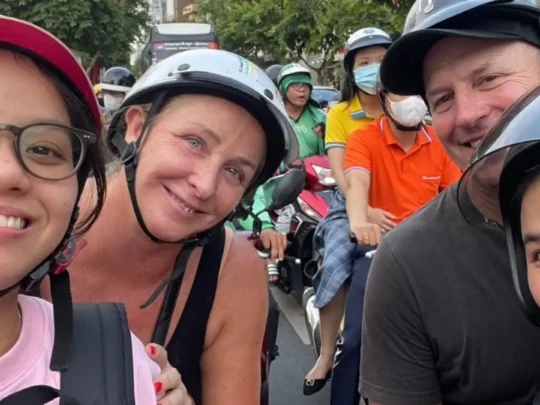 International tourists experiencing Ho Chi Minh City streets on a guided motorbike tour