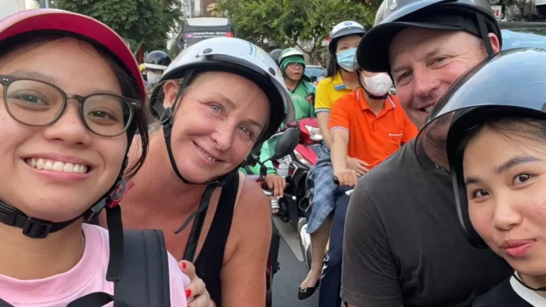 International tourists experiencing Ho Chi Minh City streets on a guided motorbike tour