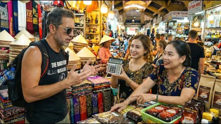 Tourists interacting with vendors at Ben Thanh Market during Ho Chi Minh City tour