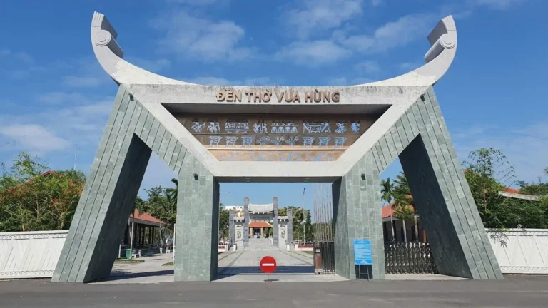 Main entrance gate with traditional curved roof and stone pillars at Hung King Temple Can Tho