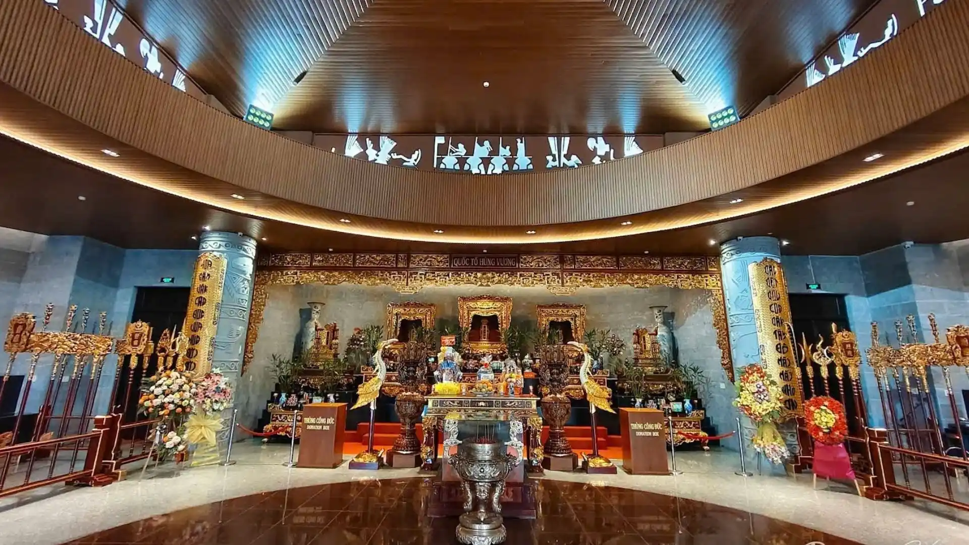 Interior space with wooden decor and heritage exhibits at Hung King Temple Can Tho