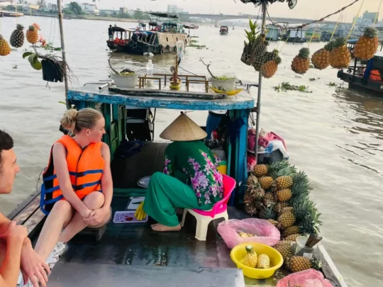 Tourists visiting floating market on Mekong Delta 2 days tour