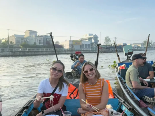 Tourists enjoying Mekong River boat ride during Mekong Delta 2 days tour