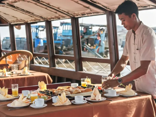 Crew preparing breakfast onboard Bassac Cruise on a luxury Mekong Delta cruise in Can Tho