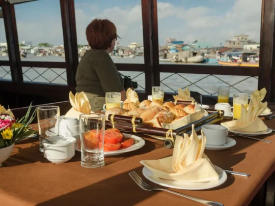 Breakfast with river view onboard Bassac Cruise during a Mekong Delta cruise in Can Tho, Vietnam