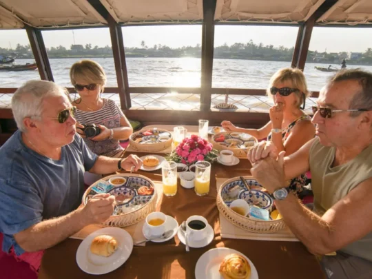 Guests enjoying breakfast onboard Bassac Cruise during a Mekong Delta cruise in Can Tho