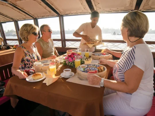 Guests enjoying a luxury breakfast onboard Bassac Cruise during a Mekong Delta cruise in Can Tho