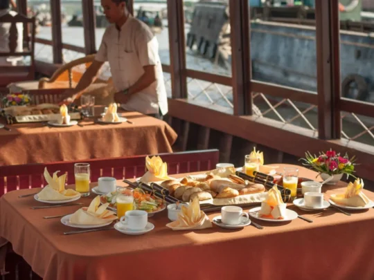 Luxury breakfast table setup onboard Bassac Cruise during a Mekong Delta cruise in Can Tho