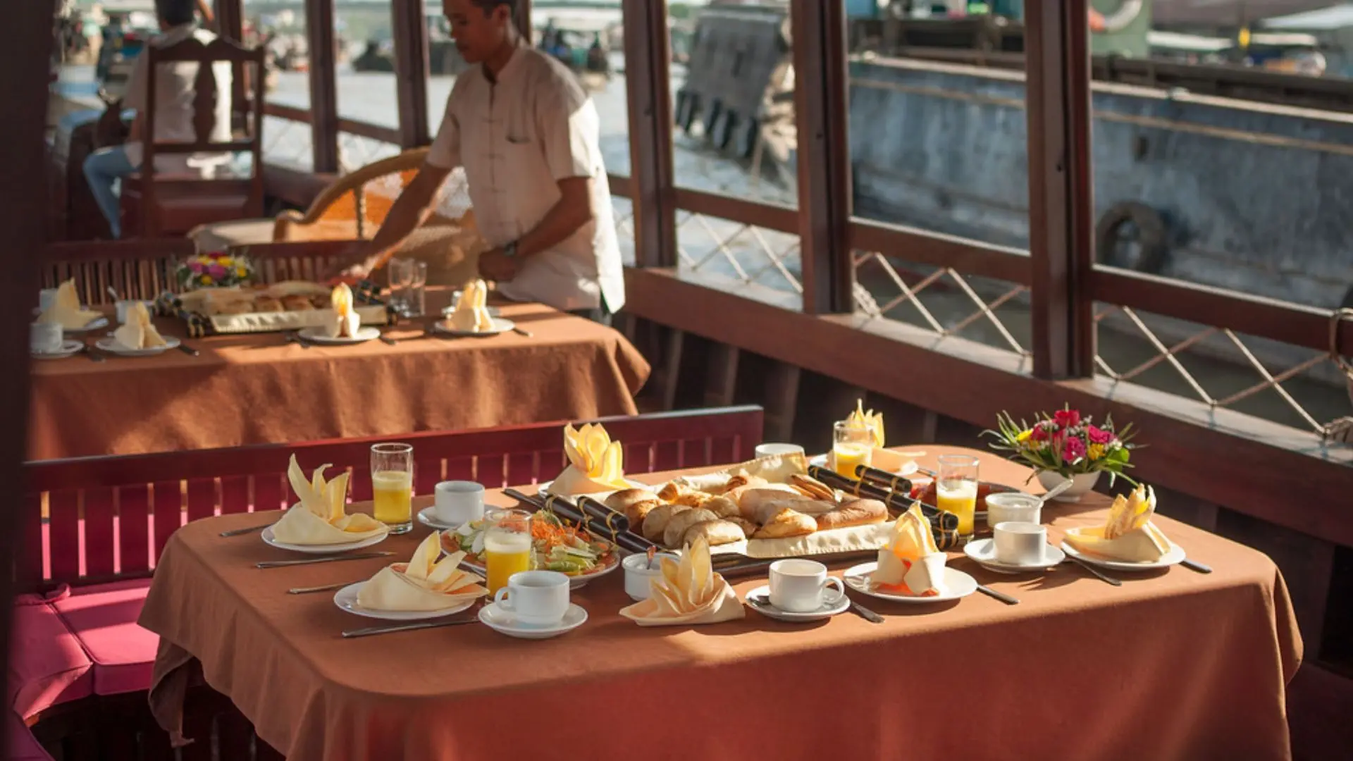 Luxury breakfast table setup onboard Bassac Cruise during a Mekong Delta cruise in Can Tho