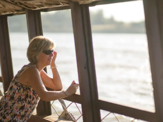 Guest relaxing on Bassac Cruise while cruising the Mekong Delta in Can Tho, Vietnam