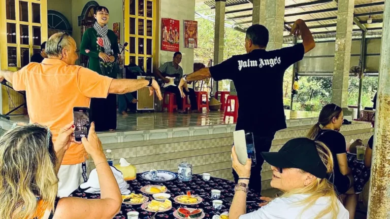 Tourists listening to a live performance of Southern Vietnamese folk music in Mekong Delta Tour Cai Be