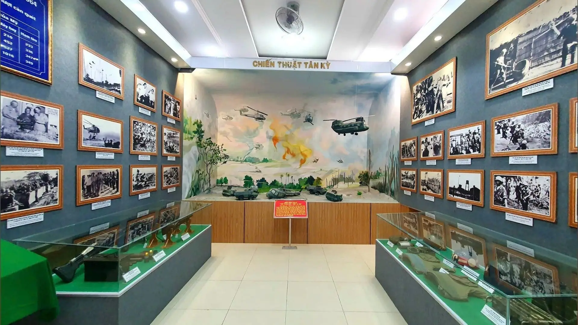 Indoor exhibition hall of Military Zone 9 Museum in Can Tho with historical photos and artifacts