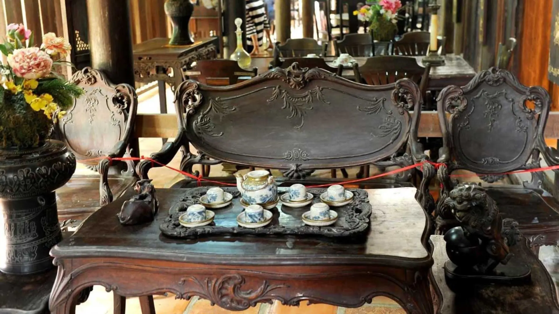 Mr Kiet Ancient House Cai Be: Vietnam’s 108 Pillar Heritage Home 158 Antique wooden table set with a porcelain tea service at Mr Kiet Ancient House