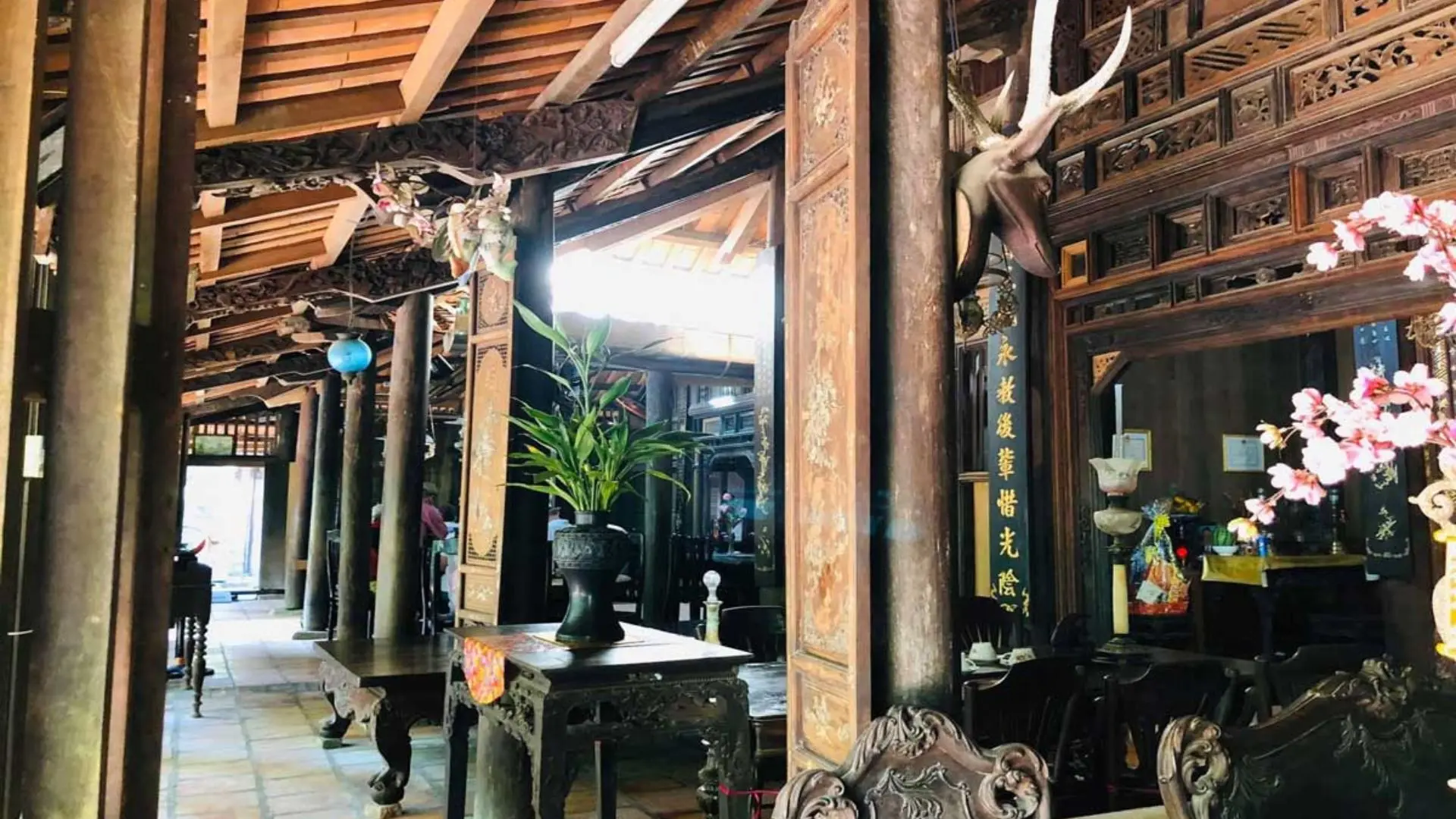Historical dark wood furniture and interior of the main parlor at Mr Kiet Ancient House