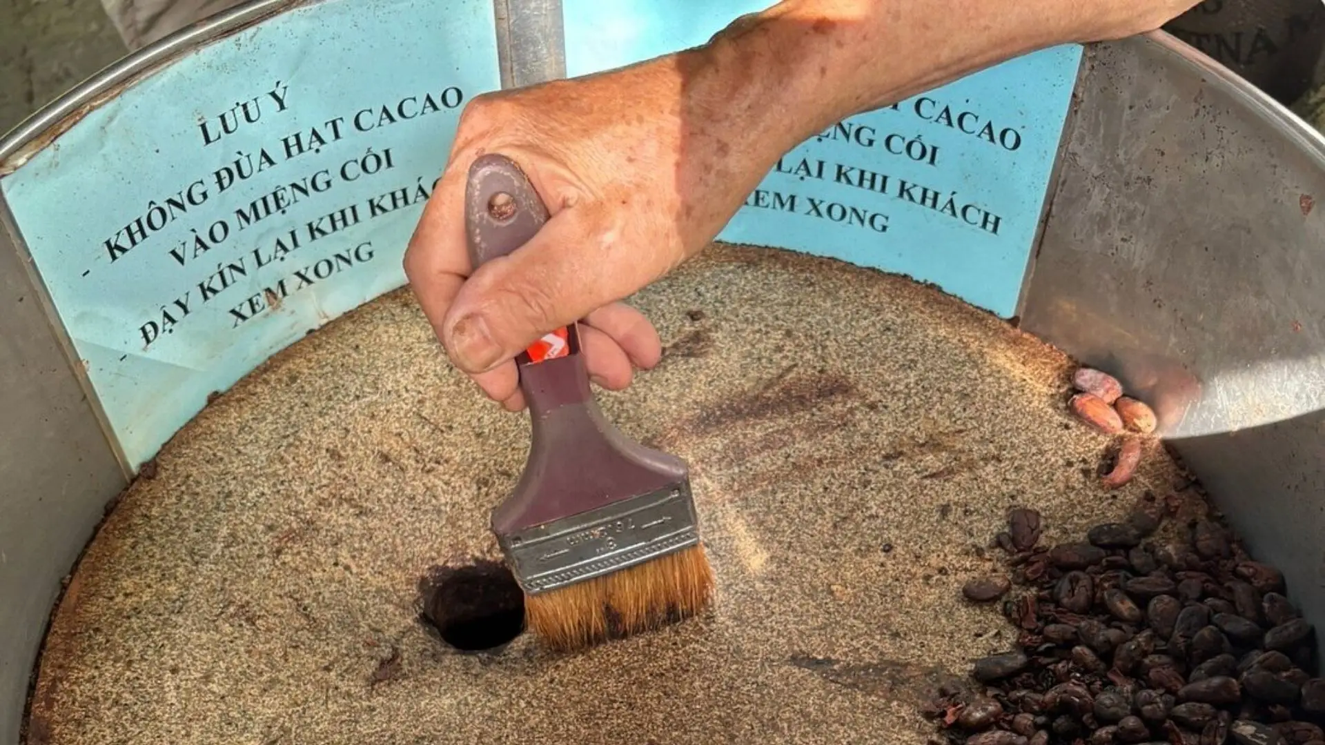 Grinding roasted cacao beans by hand