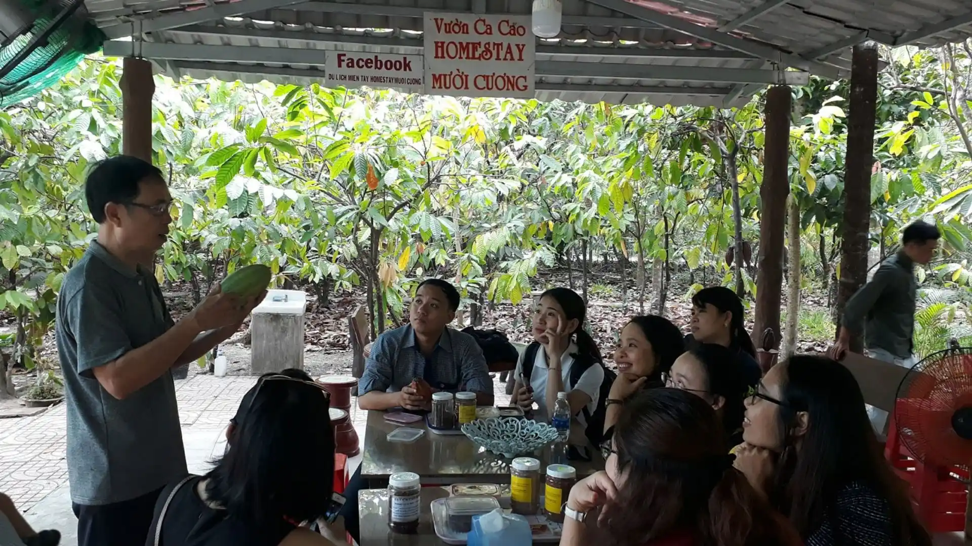 A group of visitors enjoying a cacao garden tour together
