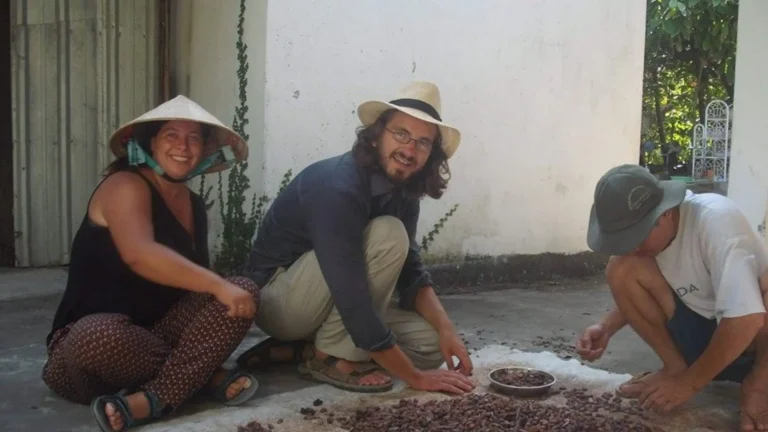 Visitors learning traditional cacao processing at a local garden
