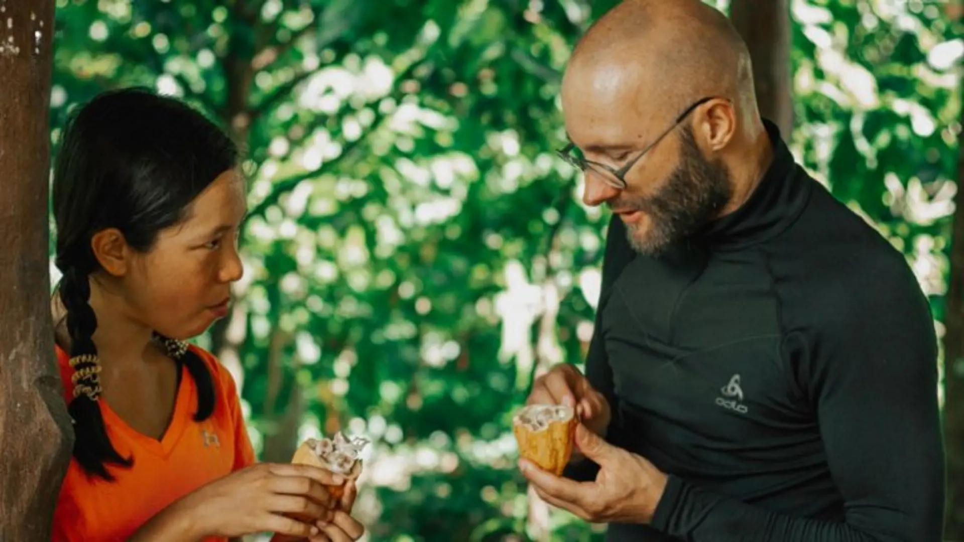 Visitors tasting fresh cacao products at the garden